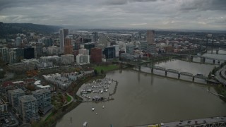 AX155_049E - 5.5K aerial stock footage flying over Marquam Bridge near Riverplace Marina and Hawthorne Bridge to pass skyscrapers in Downtown Portland, Oregon
