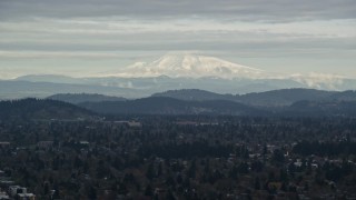 AX155_062 - 5.5K aerial stock footage of snowy Mount Hood seen from suburban residential neighborhoods in Portland, Oregon
