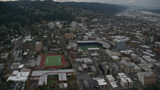 AX155_065 - 5.5K aerial stock footage approaching Providence Park beside Lincoln High School's football field Portland, Oregon
