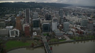 AX155_070E - 5.5K aerial stock footage following Hawthorne Bridge toward riverfront park and skyscrapers in Downtown Portland, Oregon