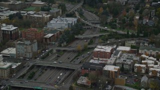 AX155_072 - 5.5K aerial stock footage of I-405 freeway and overpasses beside Portland State University in Downtown Portland, Oregon