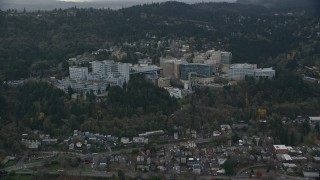 AX155_080 - 5.5K aerial stock footage approaching the Oregon Health and Science University in the hills over Portland, Oregon