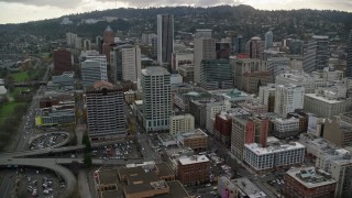 AX155_113E - 5.5K aerial stock footage passing the top of US Bancorp Tower, and city streets and skyscrapers in Downtown Portland, Oregon