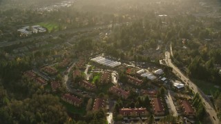 AX155_120 - 5.5K aerial stock footage flying by apartments and greenhouses in Southwest Portland, Oregon