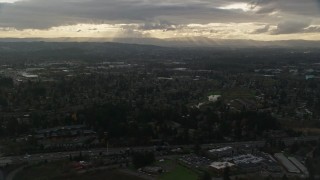 AX155_123 - 5.5K aerial stock footage flying by suburban neighborhood with a lot of trees in Beaverton, Oregon, sunset