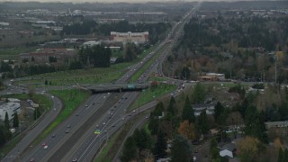 AX155_128 - 5.5K aerial stock footage following Highway 26 with light traffic through Hillsboro, Oregon, twilight