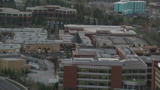 AX155_129 - 5.5K aerial stock footage flying by office buildings and reveal apartment buildings in Hillsboro, Oregon, twilight