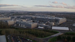AX155_132 - 5.5K aerial stock footage flying over Intel Ronler Acres Campus at sunset, in Hillsboro, Oregon