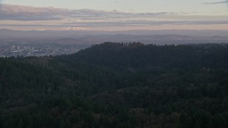 AX155_139 - 5.5K aerial stock footage of Mount Hood and Downtown Portland at sunset, seen from forest and hills in Northwest Portland, Oregon