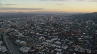 AX155_143 - 5.5K stock footage aerial video flying over Northwest Portland at twilight to approach I-405 and Downtown Portland
