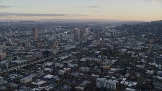 AX155_143E - 5.5K aerial stock footage flying over Northwest Portland at twilight to approach I-405 and Downtown Portland