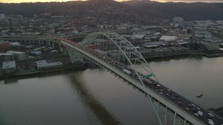 AX155_159 - 5.5K aerial stock footage orbiting heavy traffic crossing the Fremont Bridge at twilight, and reveal Downtown Portland, Oregon