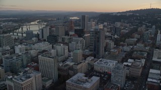 AX155_164E - 5.5K aerial stock footage flying over Park Avenue West Tower and Wells Fargo Center at twilight in Downtown Portland, Oregon