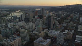 AX155_165 - 5.5K aerial stock footage flying over Park Avenue West Tower at twilight to approach KOIN Center and Wells Fargo Center in Downtown Portland, Oregon