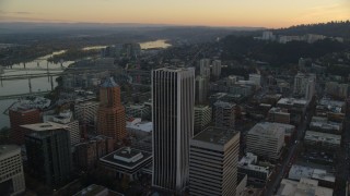 AX155_166 - 5.5K aerial stock footage flying over Wells Fargo Center at twilight in Downtown Portland, Oregon, and reveal streets through the south part of Portland