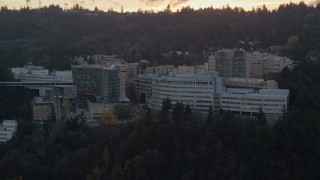AX155_167E - 5.5K aerial stock footage of the Oregon Health and Science University in Portland, Oregon, twilight