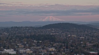 AX155_177 - 5.5K aerial stock footage of Northeast Portland neighborhoods with Mount Hood in the distance at twilight, Oregon