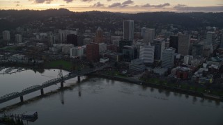 AX155_178E - 5.5K aerial stock footage fly over the Willamette River and Downtown Portland at twilight in Oregon