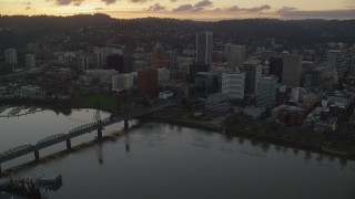 AX155_179 - 5.5K aerial stock footage flying over the Willamette River and approach Downtown Portland at twilight in Oregon