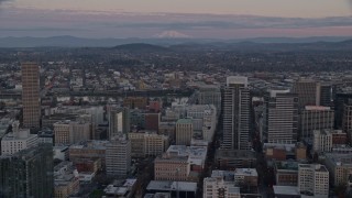 AX155_181 - 5.5K aerial stock footage of Mount Hood seen from US Bancorp Tower at twilight in Downtown Portland, Oregon