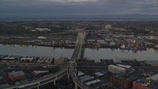 AX155_182 - 5.5K aerial stock footage orbiting the Fremont Bridge with very heavy traffic at twilight, Portland, Oregon