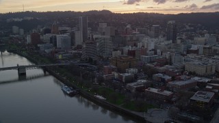 AX155_185E - 5.5K aerial stock footage of Downtown Portland skyscrapers, flyby Union Station and bridges at twilight in Oregon