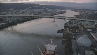 AX155_208 - 5.5K aerial stock footage approaching and flying by heavy traffic on both decks of the Fremont Bridge, twilight, Portland, Oregon
