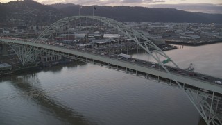 AX155_209 - 5.5K aerial stock footage orbiting heavy rush-hour traffic on both decks of the Fremont Bridge, and reveal Downtown Portland, Oregon, twilight