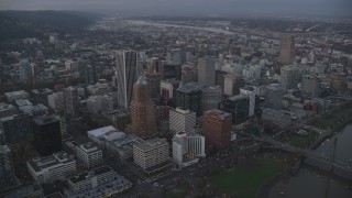 AX155_215 - 5.5K aerial stock footage flying over KOIN Center, Wells Fargo Center, and Portland City Hall at twilight, Downtown Portland, Oregon
