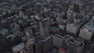 AX155_215E - 5.5K aerial stock footage flying over KOIN Center, Wells Fargo Center, and Portland City Hall at twilight, Downtown Portland, Oregon