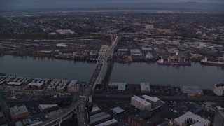AX155_217 - 5.5K aerial stock footage orbiting the Fremont Bridge with heavy traffic spanning Willamette River at twilight, Portland, Oregon