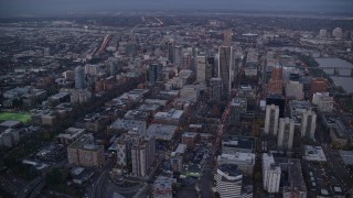 AX155_228 - 5.5K aerial stock footage flying over streets toward Wells Fargo Center and tilt down at twilight, Downtown Portland, Oregon