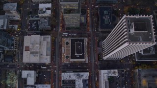 AX155_229E - 5.5K aerial stock footage of a bird's eye view of buildings between SW 6th Avenue SW 5th Avenue at twilight, reveal Pioneer Courthouse, Downtown Portland, Oregon
