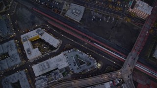 AX155_234E - 5.5K aerial stock footage of a bird's eye view of buildings between NW 6th Avenue NW 5th Avenue at twilight, reveal Greyhound bus station, Downtown Portland, Oregon