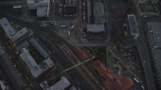 AX155_237 - 5.5K aerial stock footage of a bird's eye view of Union Station at twilight, follow NW 5th Avenue, Downtown Portland, Oregon