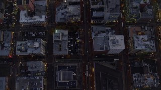 AX155_240E - 5.5K aerial stock footage of a bird's eye view follow SW 5th Avenue at twilight and reveal Pioneer Place and Courthouse, Downtown Portland, Oregon