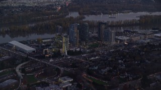 AX155_245 - 5.5K aerial stock footage of South Waterfront high-rise condo complexes by the Willamette River in Portland, Oregon, twilight