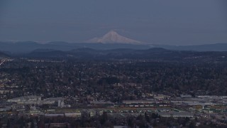 AX155_248 - 5.5K aerial stock footage of Mount Hood at twilight, seen from a train yard and neighborhoods in Southeast Portland, Oregon