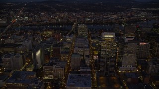 AX155_273 - 5.5K aerial stock footage flying by Park Avenue West Tower in downtown, and reveal US Bancorp Tower at night in Downtown Portland, Oregon