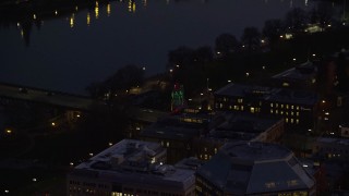 AX155_276 - 5.5K aerial stock footage of the White Stag sign and NW Naito Parkway at night in Downtown Portland, Oregon