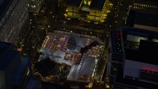 AX155_284E - 5.5K aerial stock footage orbit Pioneer Courthouse Square, decorated for Christmas, at night in Downtown Portland, Oregon