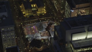 AX155_285 - 5.5K stock footage aerial video of a bird's eye orbiting Pioneer Courthouse Square, decorated for Christmas, at night in Downtown Portland, Oregon