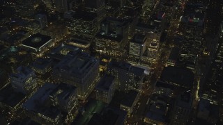 AX155_286 - 5.5K stock footage aerial video orbiting downtown to reveal Pioneer Courthouse Square, decorated for Christmas, and Pioneer Courthouse at night in Downtown Portland, Oregon