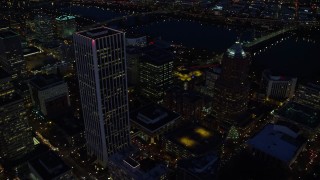 AX155_289 - 5.5K aerial stock footage flying away from Wells Fargo Center and KOIN Center near the river at night in Downtown Portland, Oregon