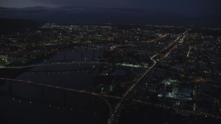 AX155_292 - 5.5K stock footage aerial video of Downtown Portland cityscape, bridges on the Willamette River at night, Oregon