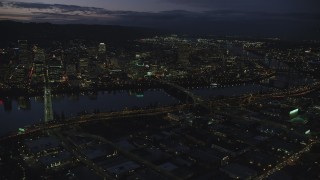 AX155_294 - 5.5K aerial stock footage of skyscrapers in downtown and Willamette River bridges at night, Downtown Portland, Oregon