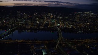AX155_294E - 5.5K aerial stock footage of skyscrapers in downtown and Willamette River bridges at night, Downtown Portland, Oregon