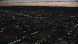 AX155_299 - 5.5K stock footage aerial video approaching office buildings, convention center, the Willamette River, and Downtown Portland at night in Oregon
