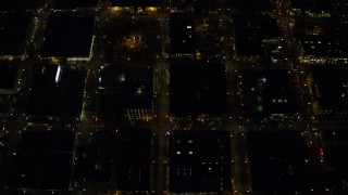 AX155_333E - 5.5K aerial stock footage of a brd's eye view of NW 5th and NW 6th Avenue at night through Downtown Portland, Oregon