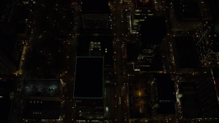 AX155_336E - 5.5K aerial stock footage of a bird's eye of SW 4th and SW 5th Avenue at night through Downtown Portland, Oregon, reveal US Bancorp Tower